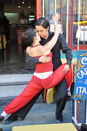 A couple dancing tango in the street
